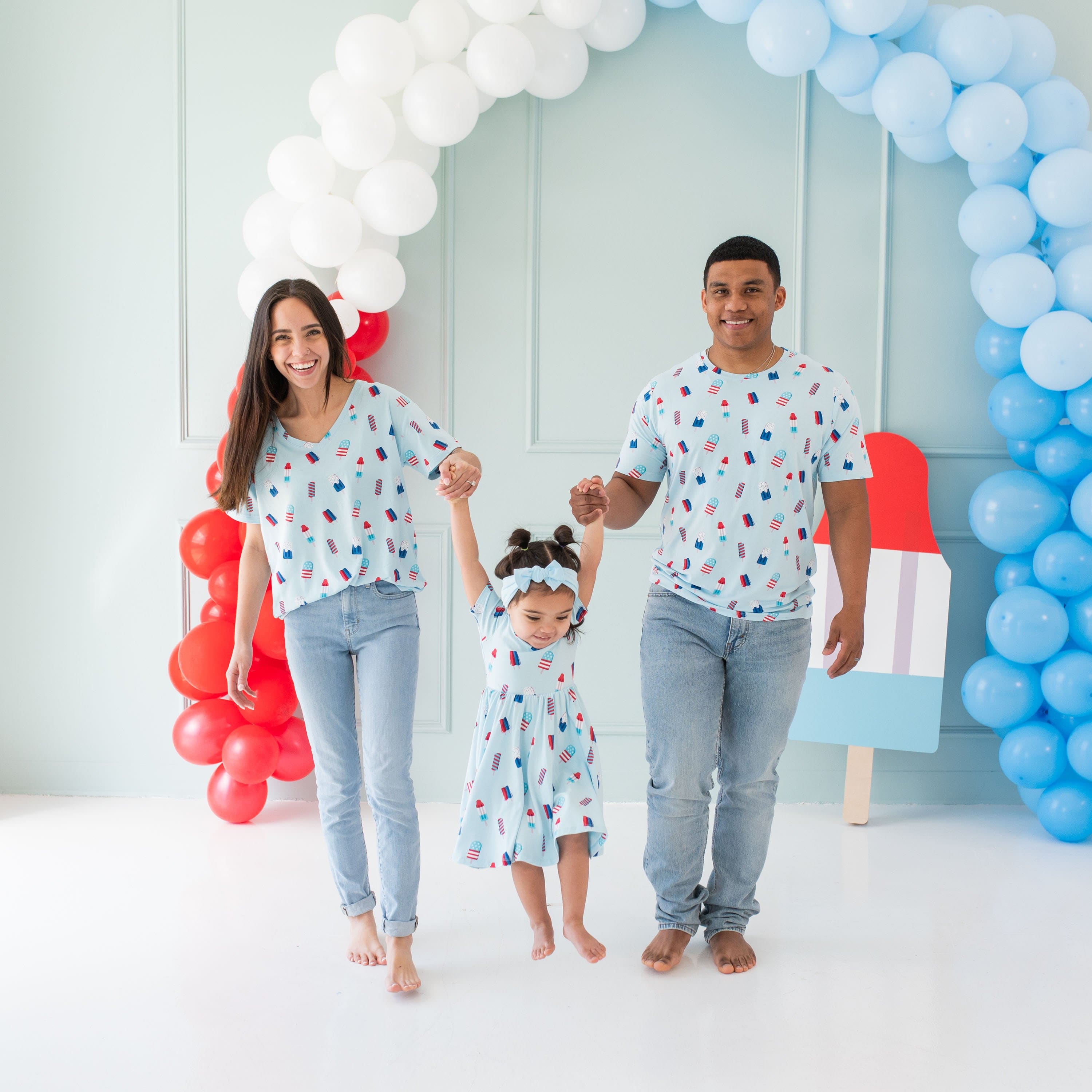 Family in matching Kyte Baby bamboo apparel in Popsicle pattern