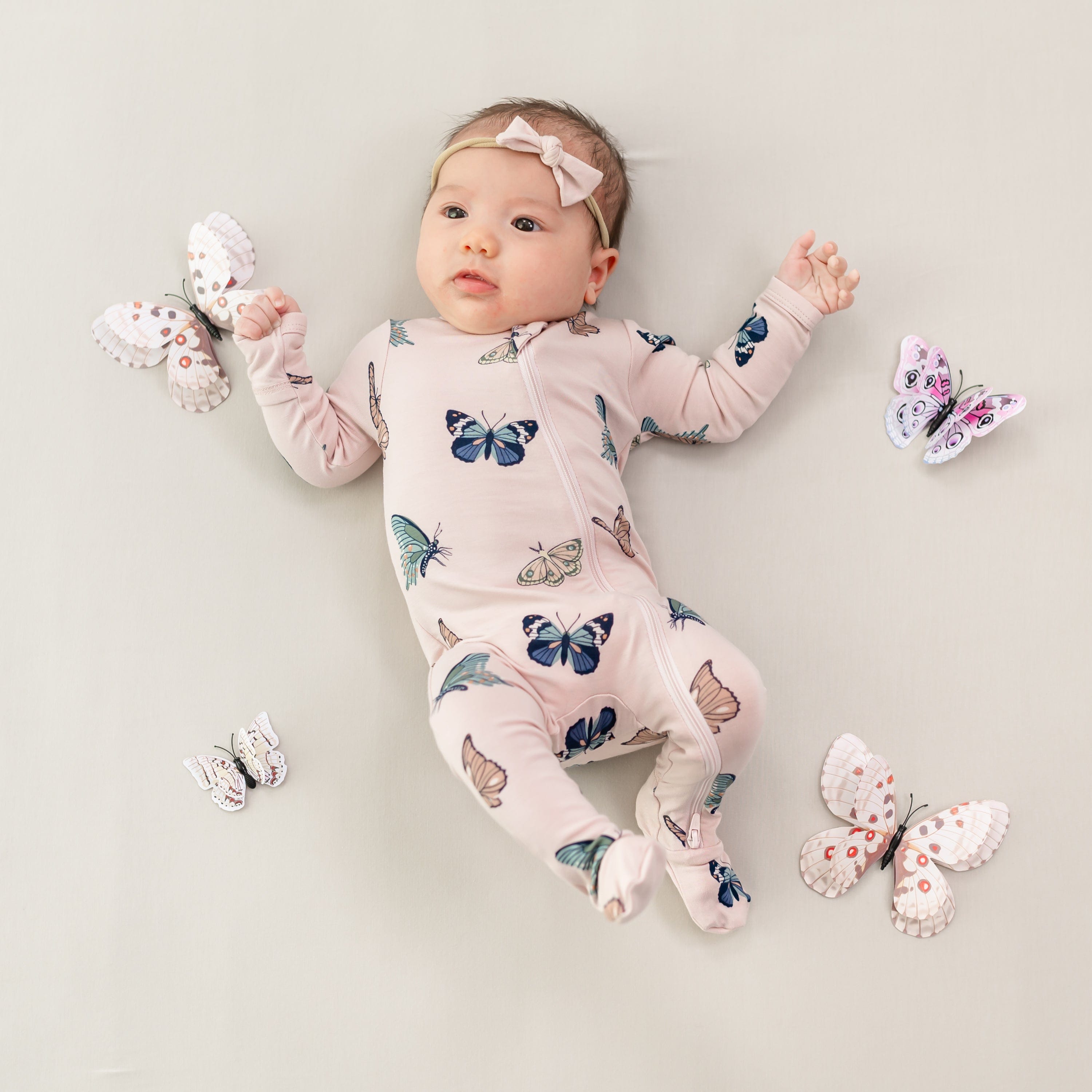 Infant wearing Zippered Footie in Blush Butterfly