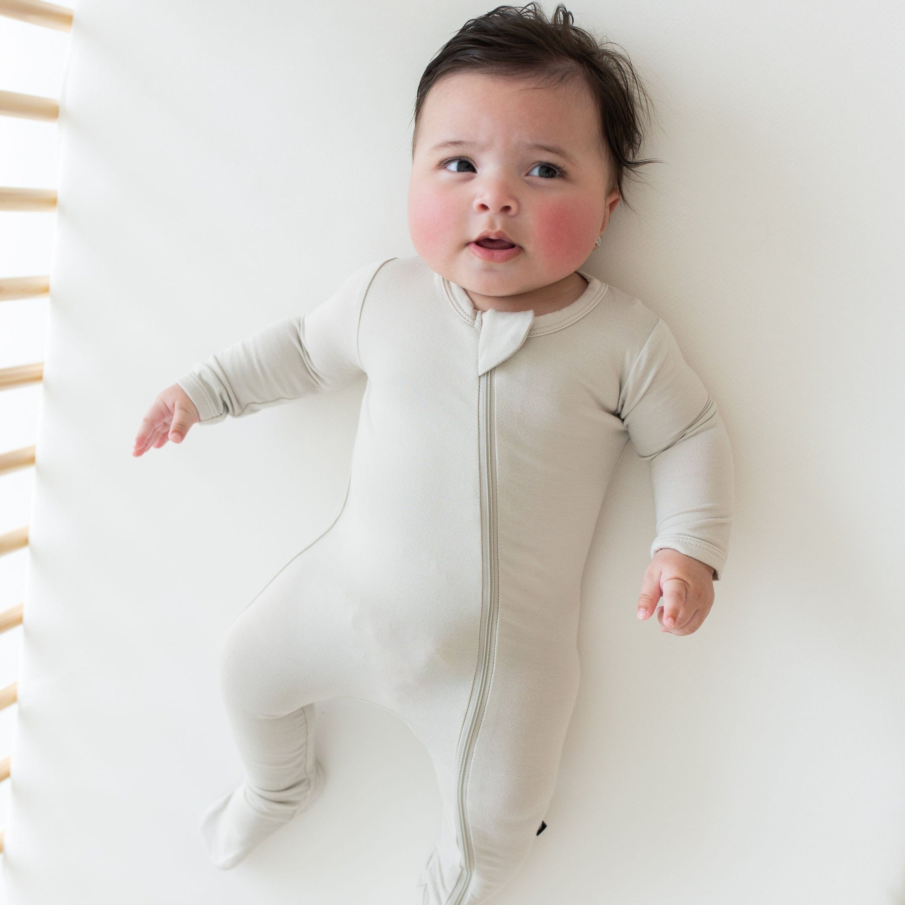 Baby wearing Kyte Baby breathable bamboo Zippered Footie in Oat