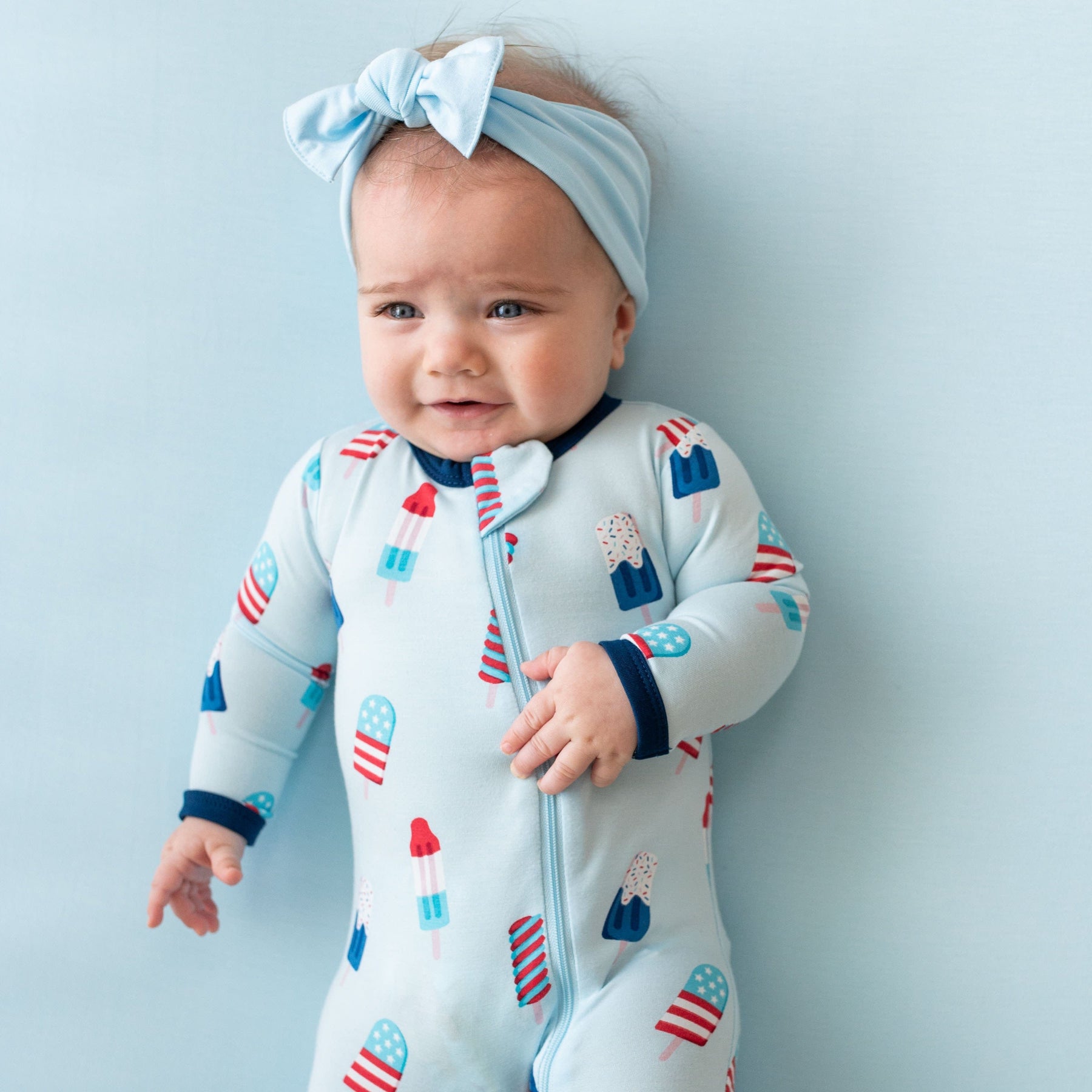 Baby wearing Kyte Baby breathable bamboo Zippered Footie in Popsicle