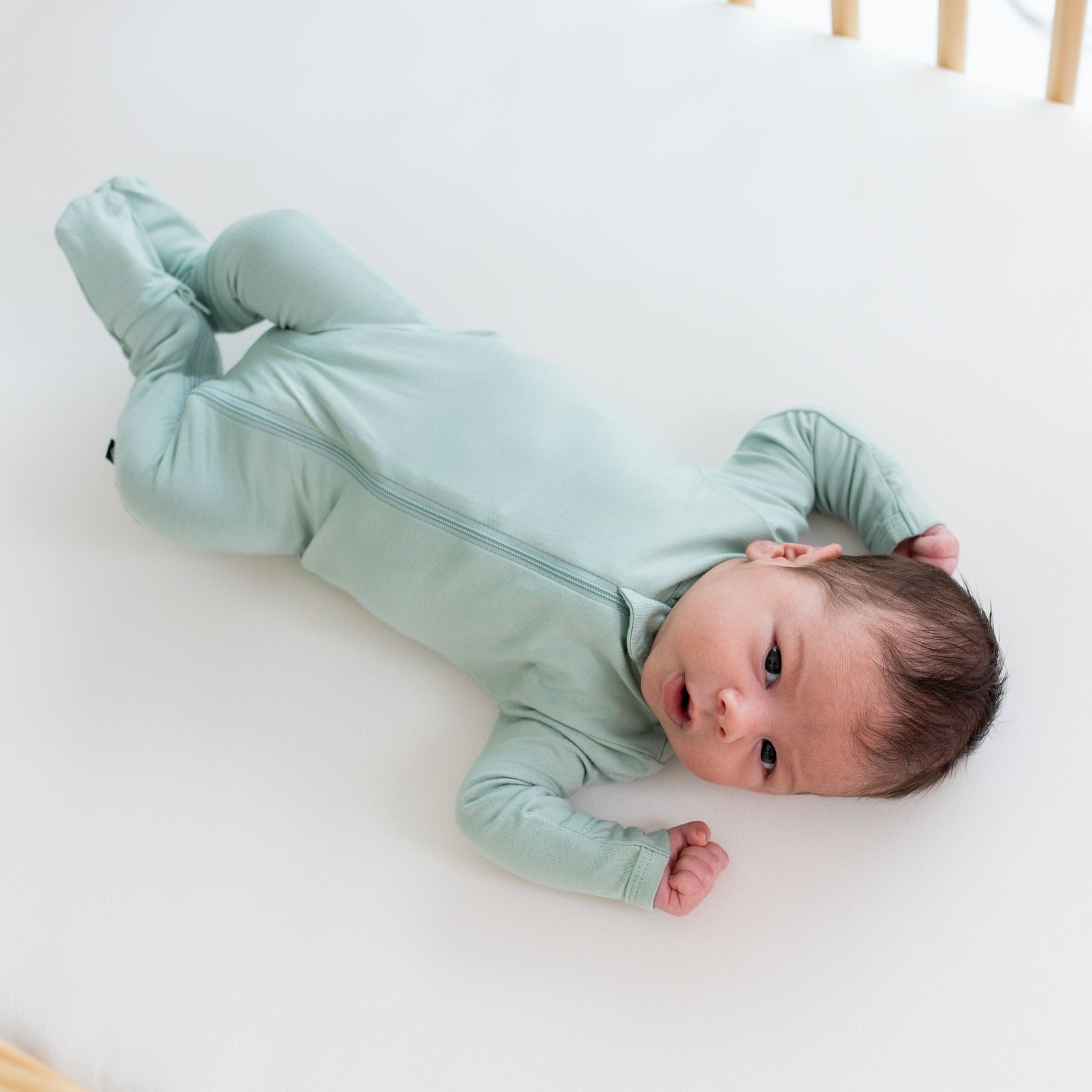 Baby wearing Kyte Baby breathable bamboo Zippered Footie in Sage