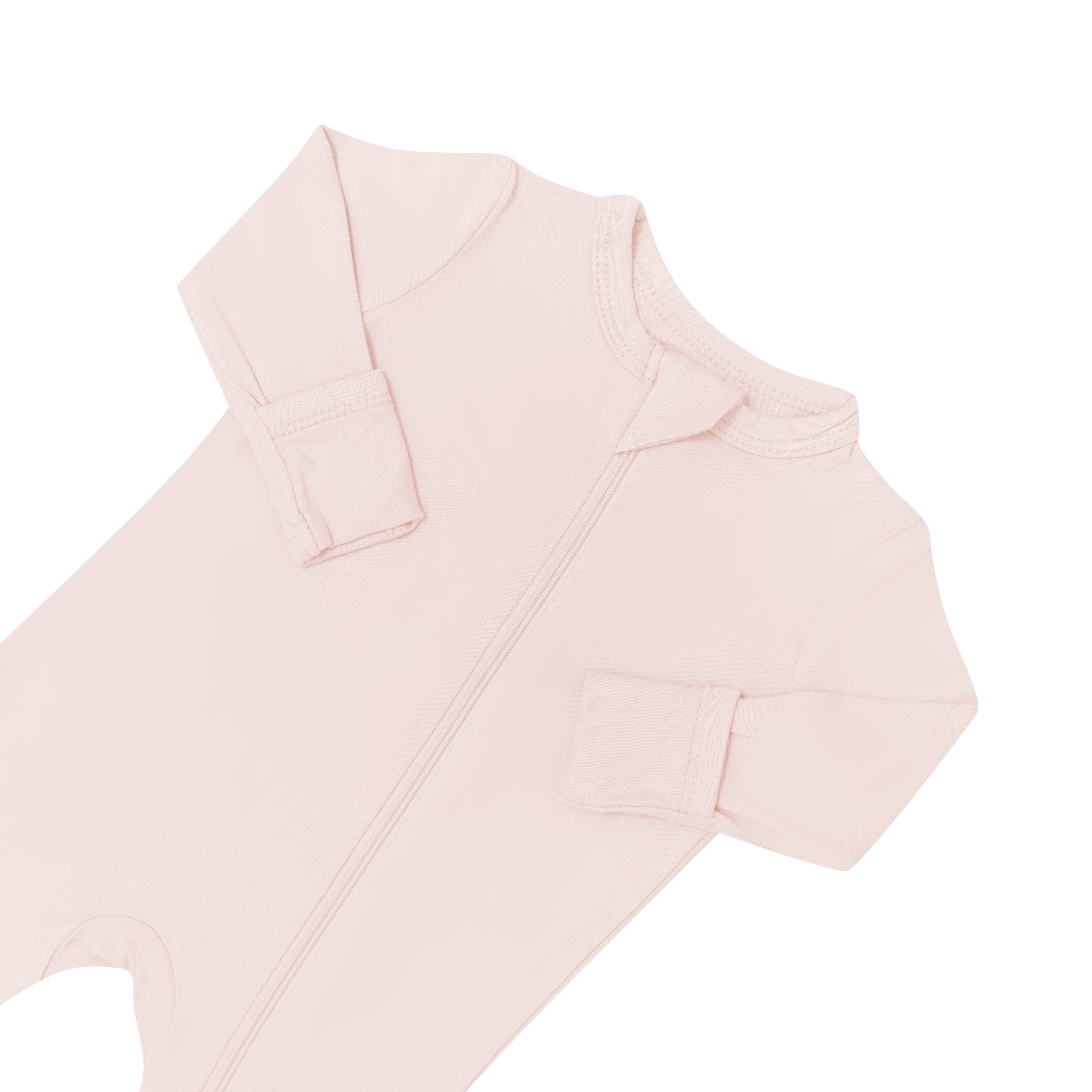 Zipper garage and fold over cuffs on Kyte Baby  Zippered Romper in Blush