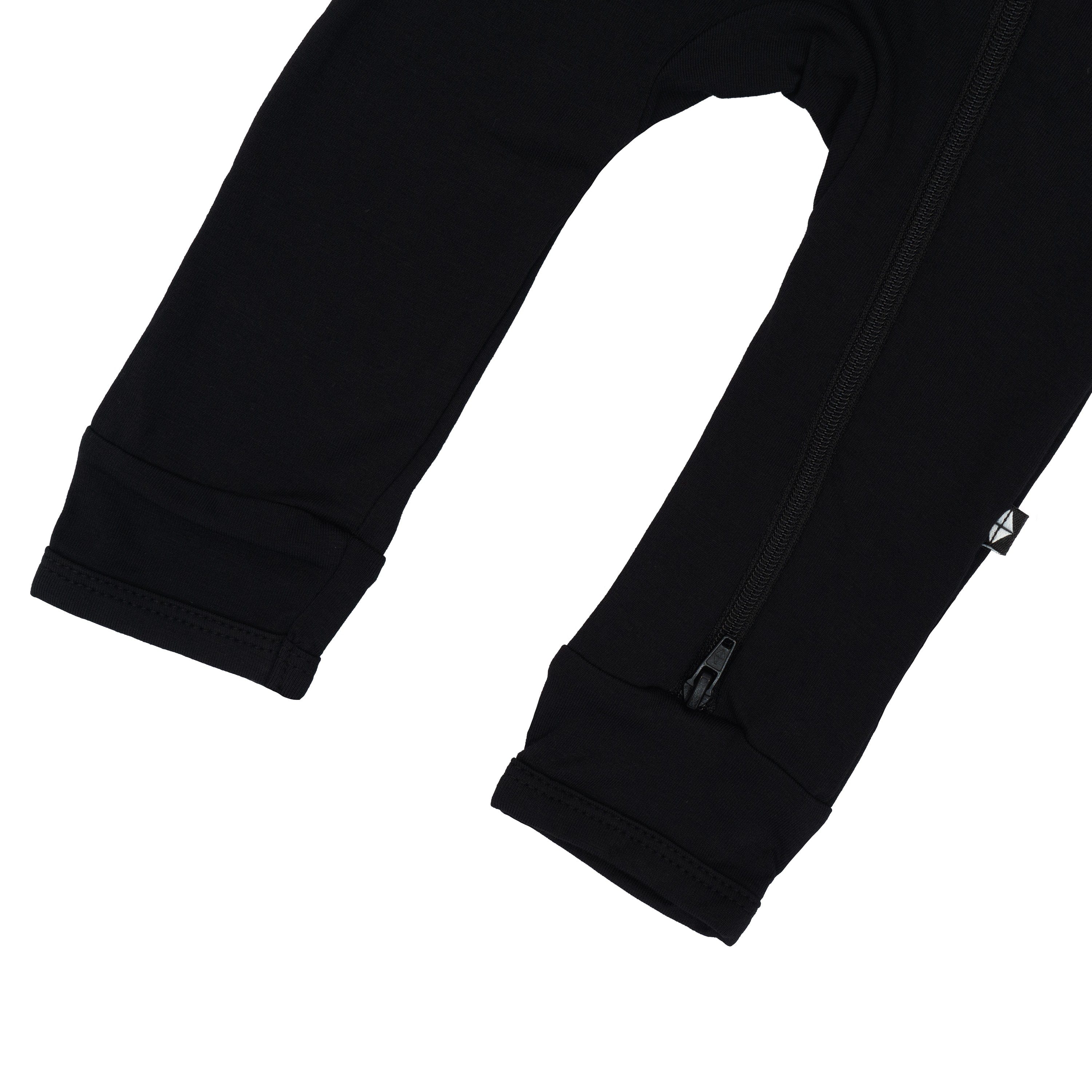 Open feet and bottom zipper on Kyte Baby Zippered Romper in Midnight