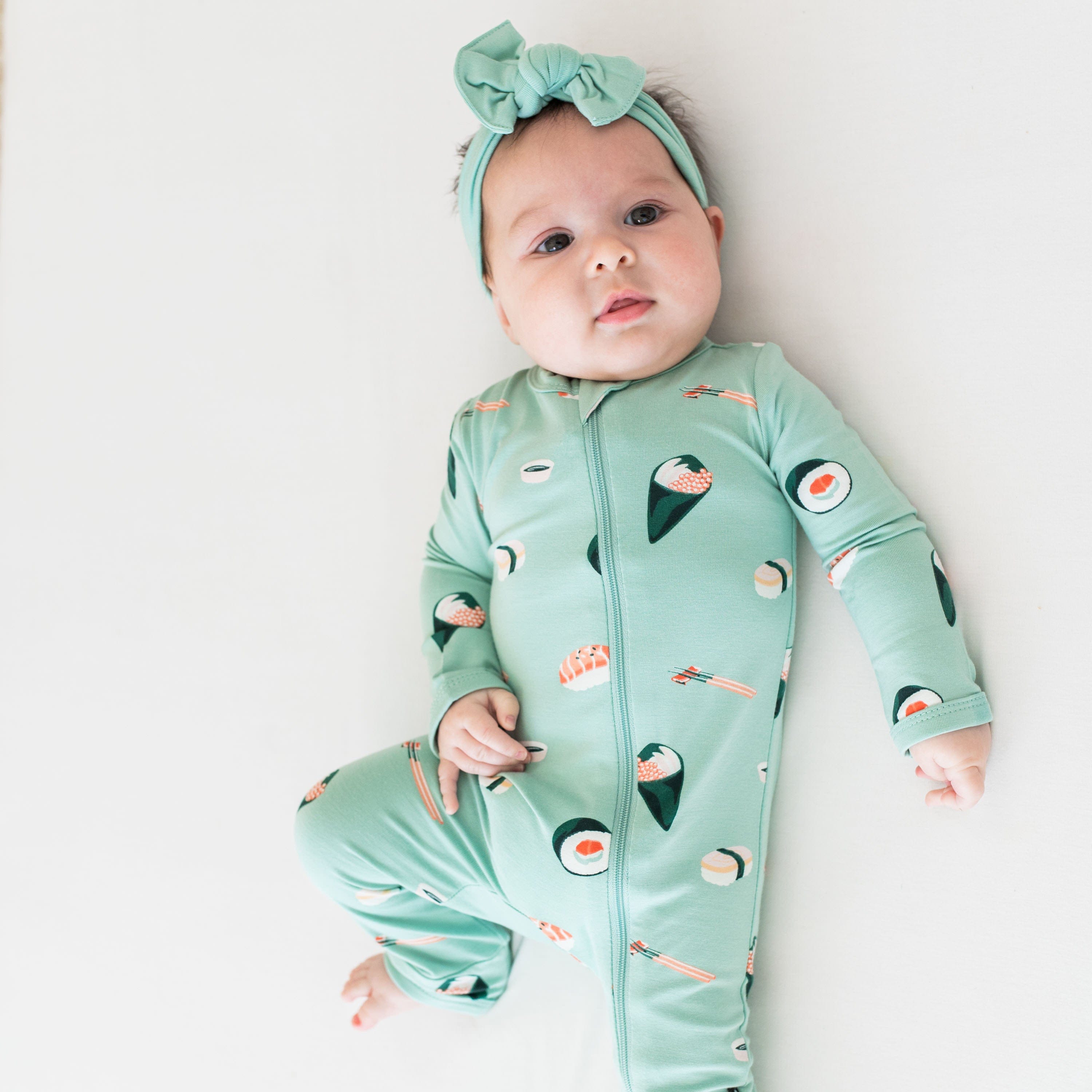 Infant wearing Kyte Baby Zippered Romper in Sushi