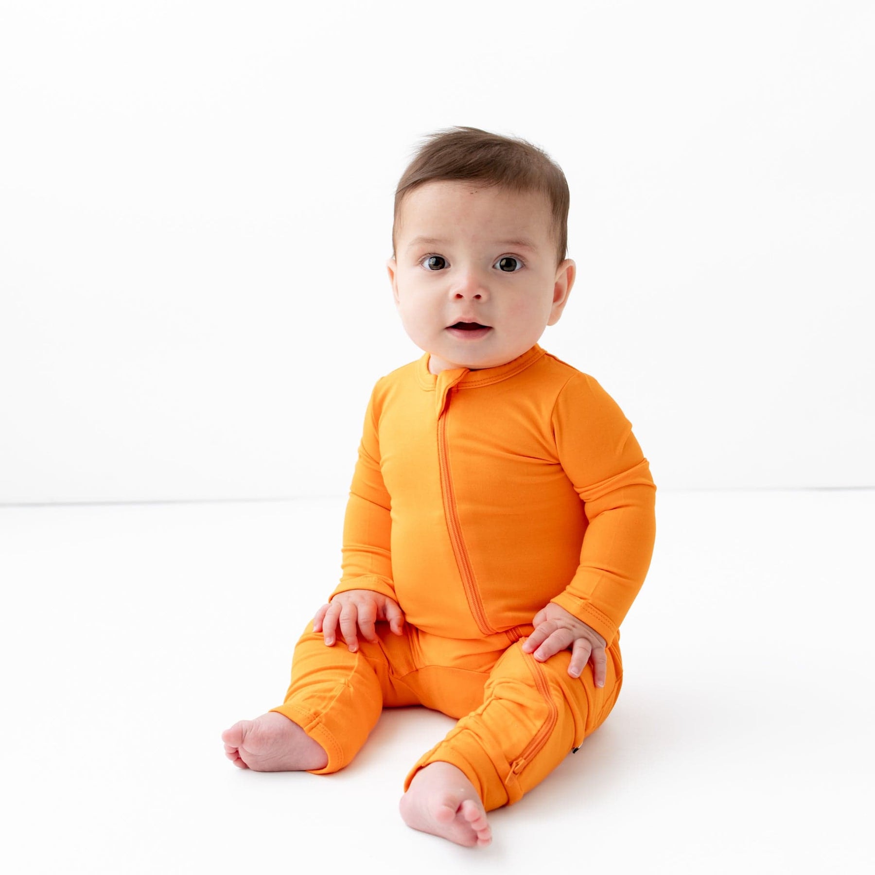 Kyte Baby Zippered Rompers Zippered Romper in Tangerine