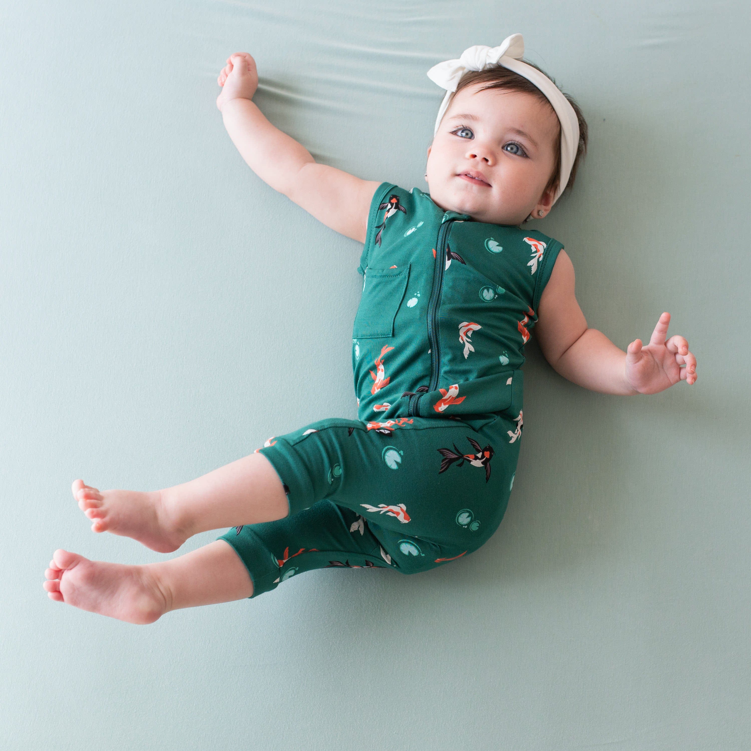 Infant wearing Kyte Baby Zippered Sleeveless Romper in Koi