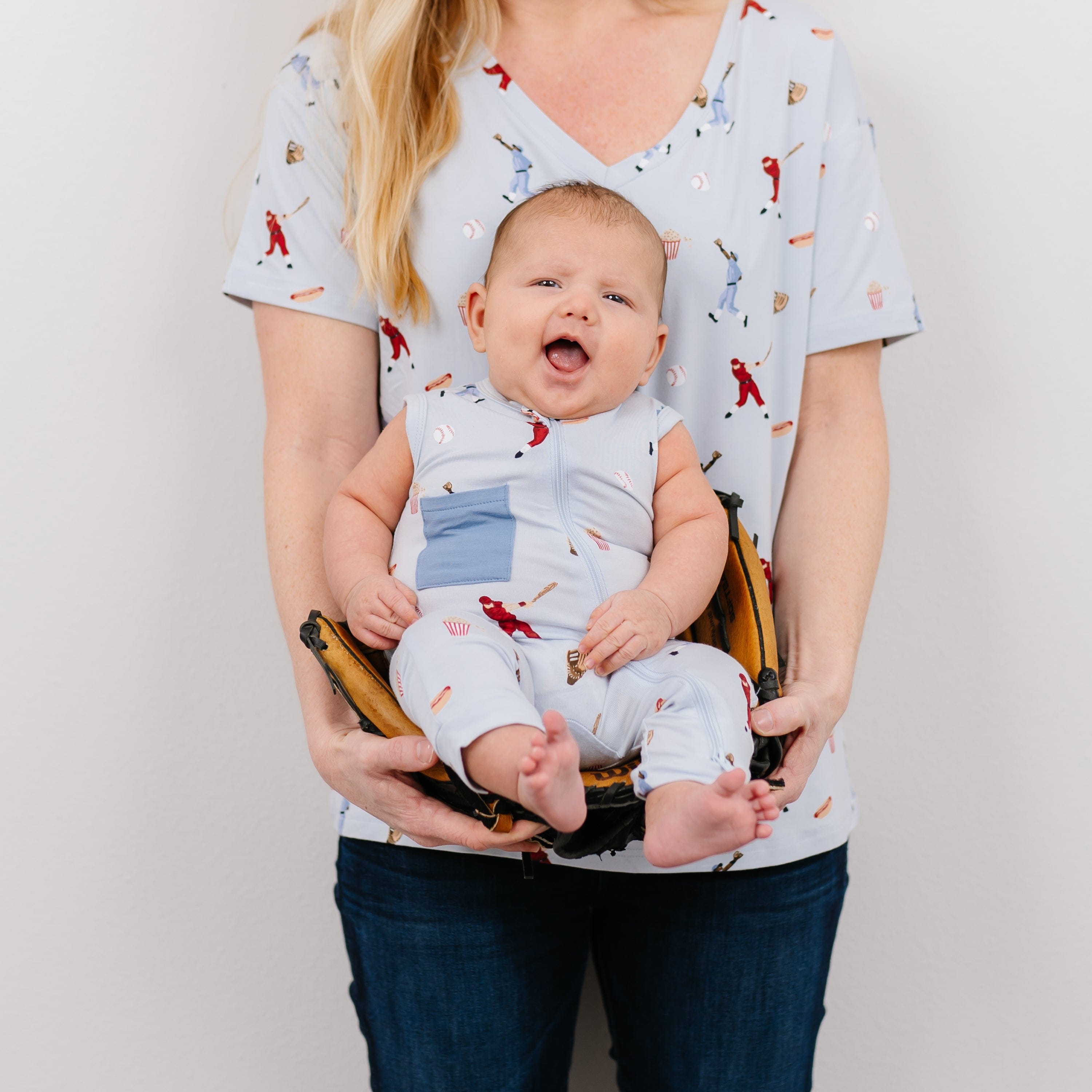 Mom and baby in coordinating Kyte Baby outfits in Vintage Baseball pattern