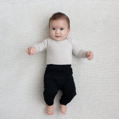 Baby modeling Pant in Midnight and Oat Long Sleeve Bodysuit