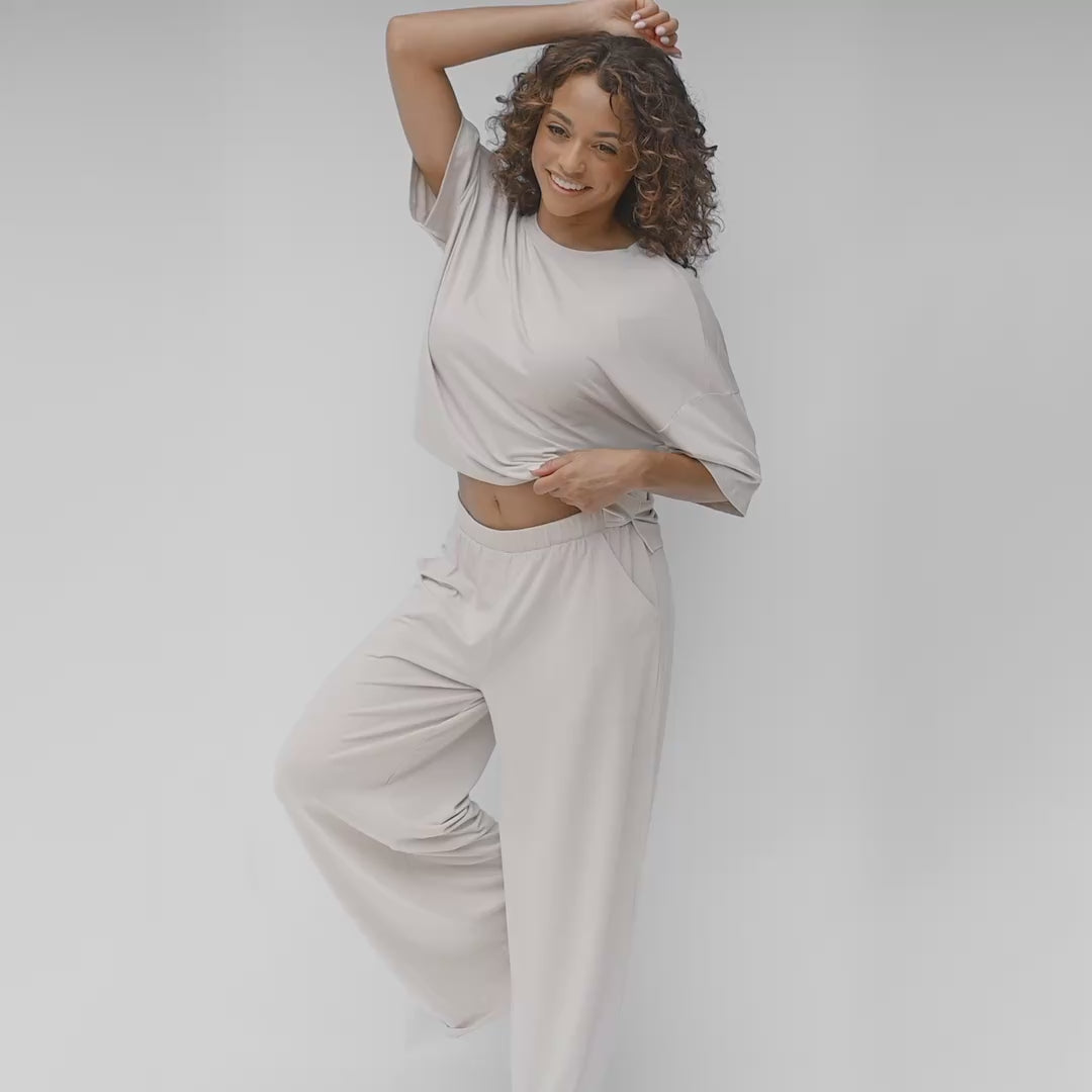 video of woman modeling a wide leg pant and tee in a creamy light grey color
