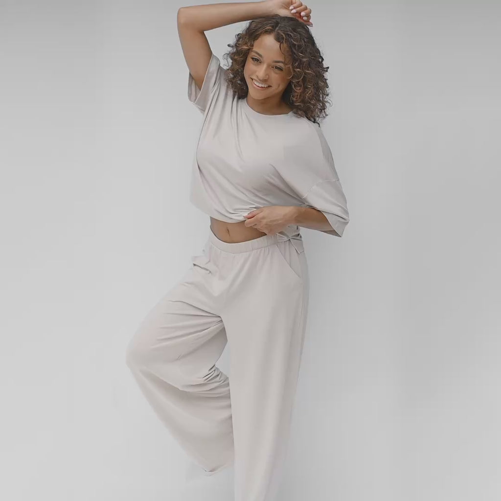 video of woman modeling a wide leg pant and tee in a creamy light grey color