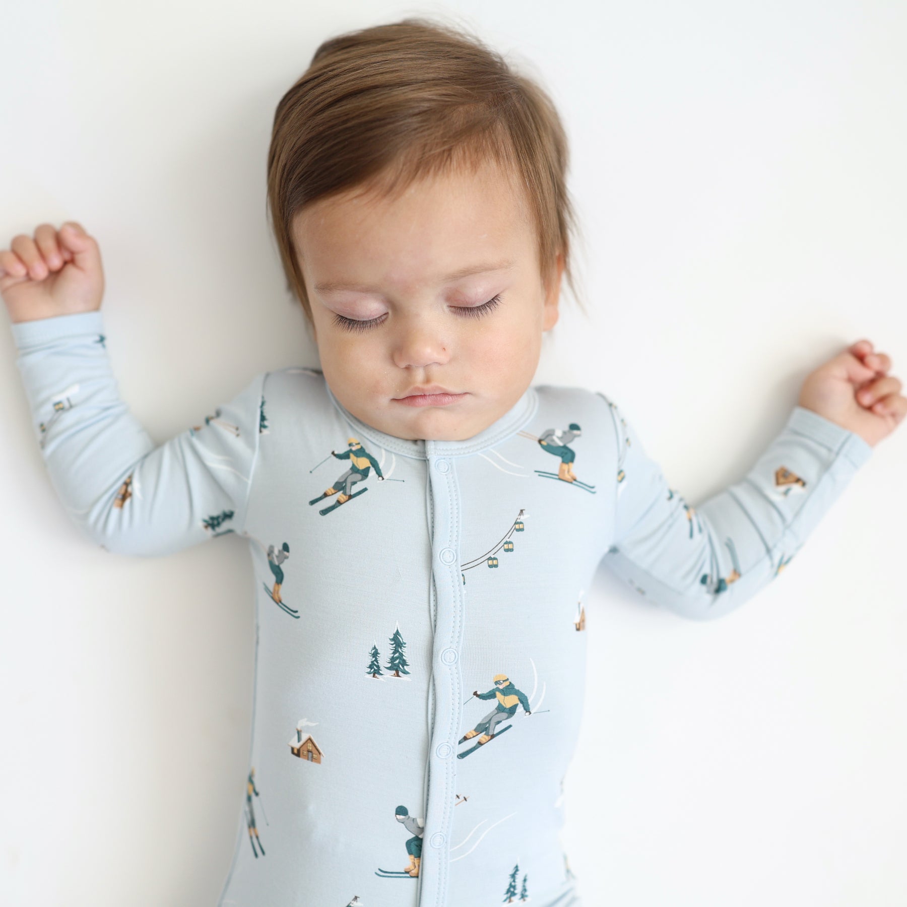 Close up of sleeping toddler wearing the Romper in Ski