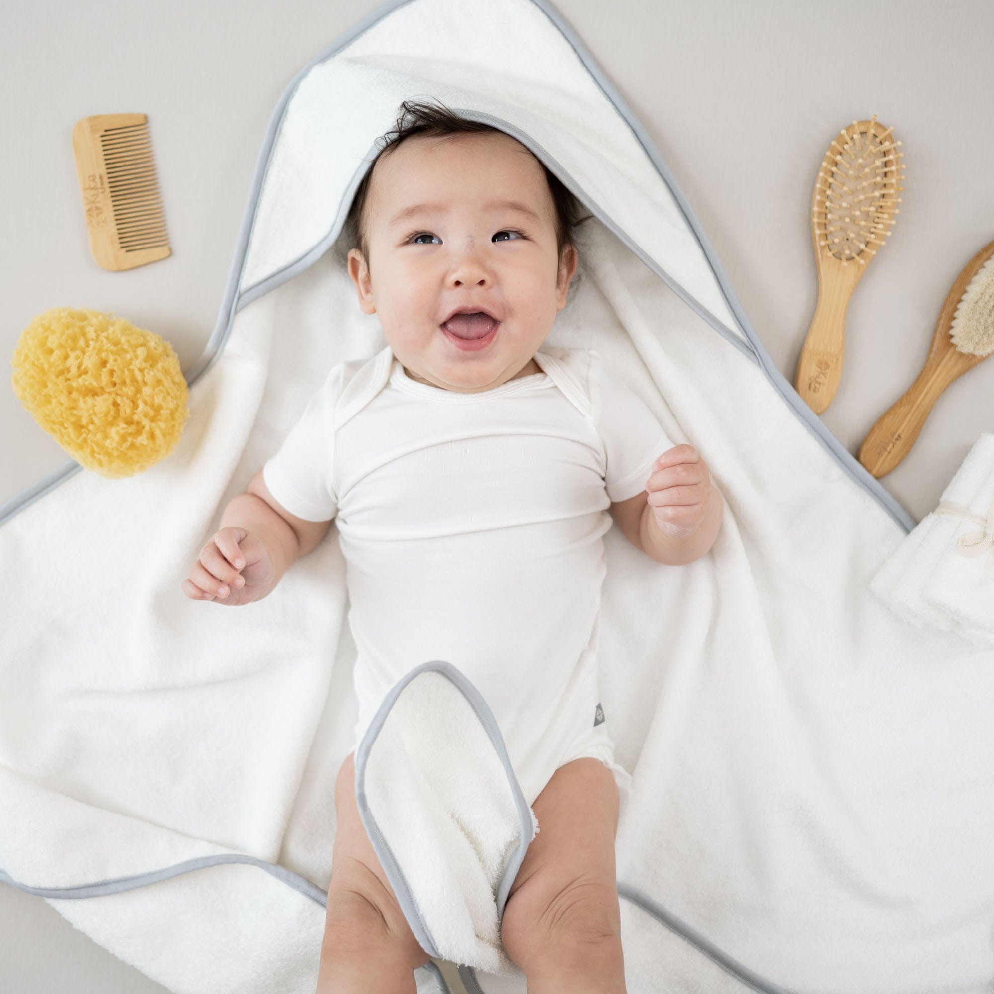 Infant with Kyte Baby Home and Bath Essentials with Sea Sponge