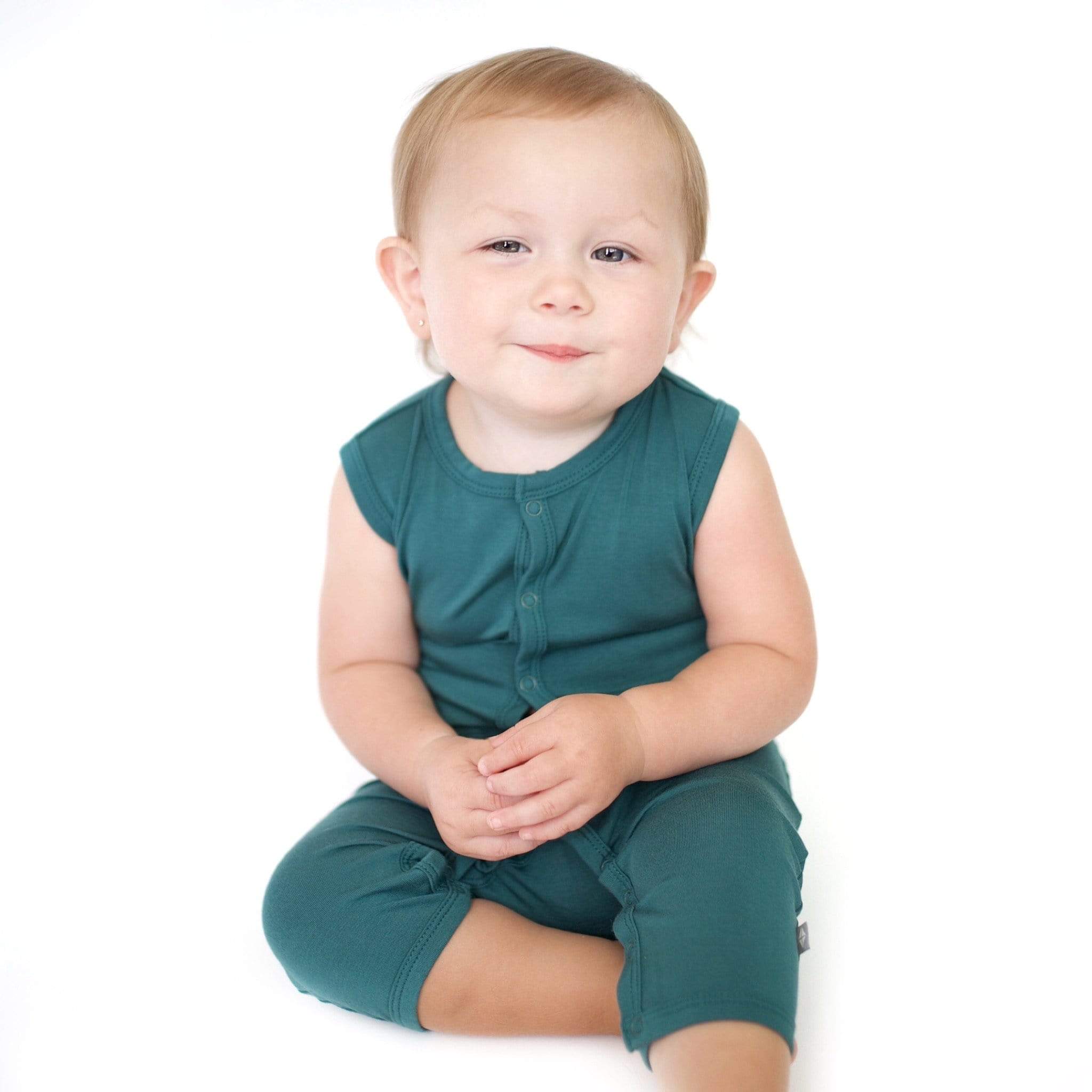 Toddler wearing Kyte Baby Sleeveless capri Romper in Emerald