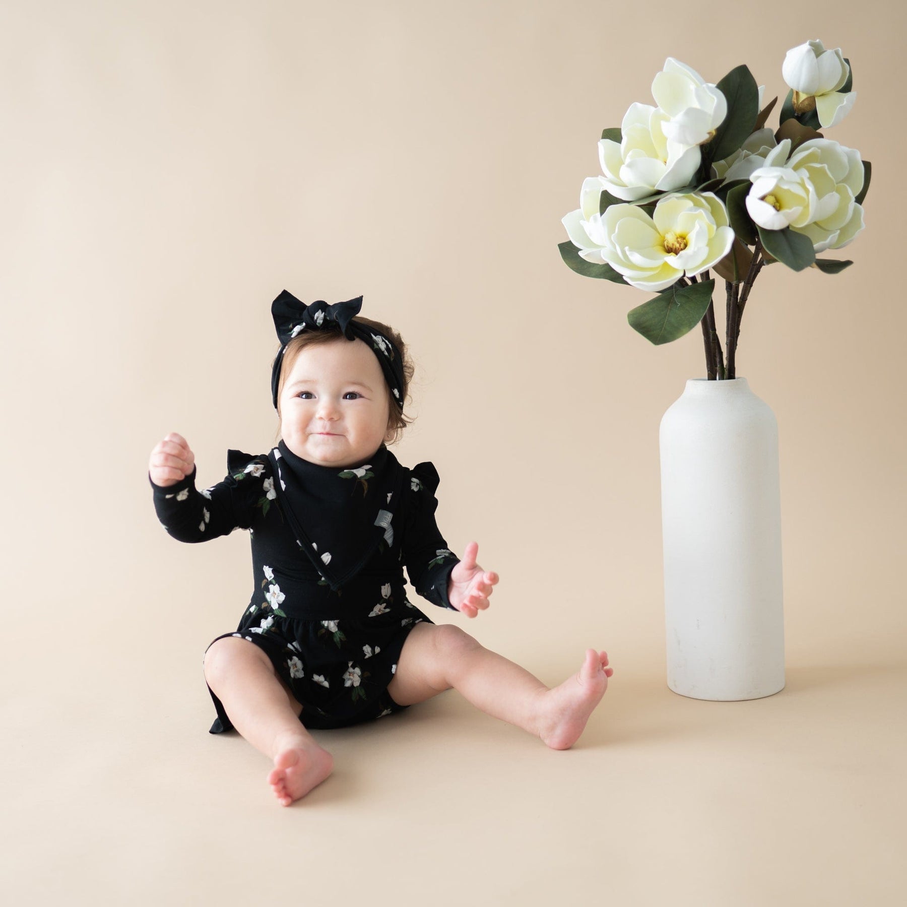 https://kytebaby.com/cdn/shop/products/kyte-baby-ls-twirl-bodysuit-dress-long-sleeve-twirl-bodysuit-dress-in-small-midnight-magnolia-31774744608879_1800x.jpg?v=1670514726