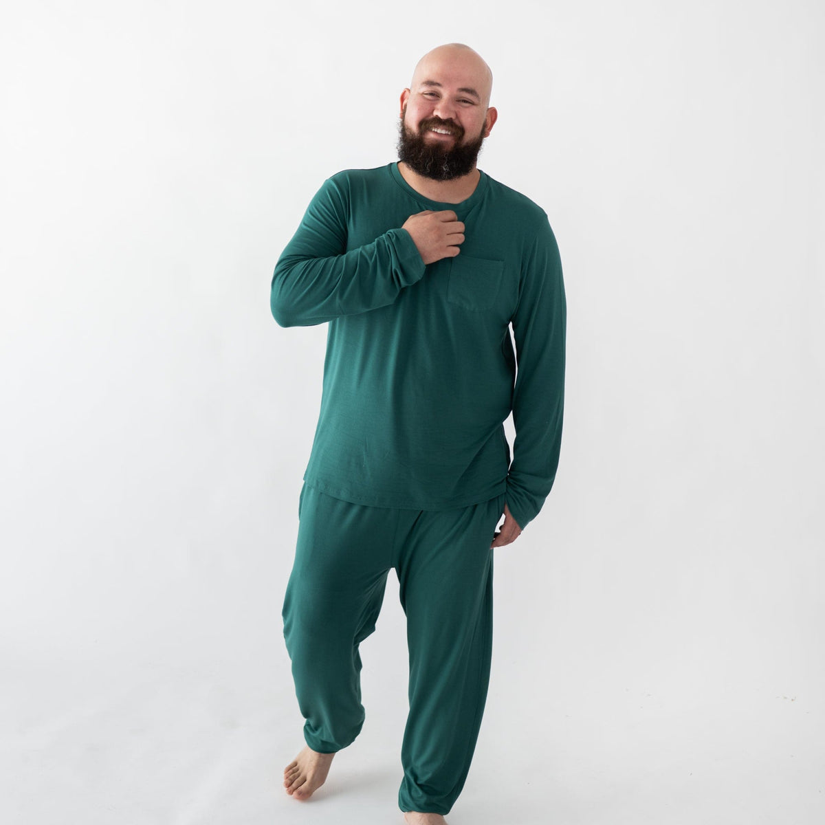 Man wearing Kyte Baby bamboo men's jogger set in Emerald