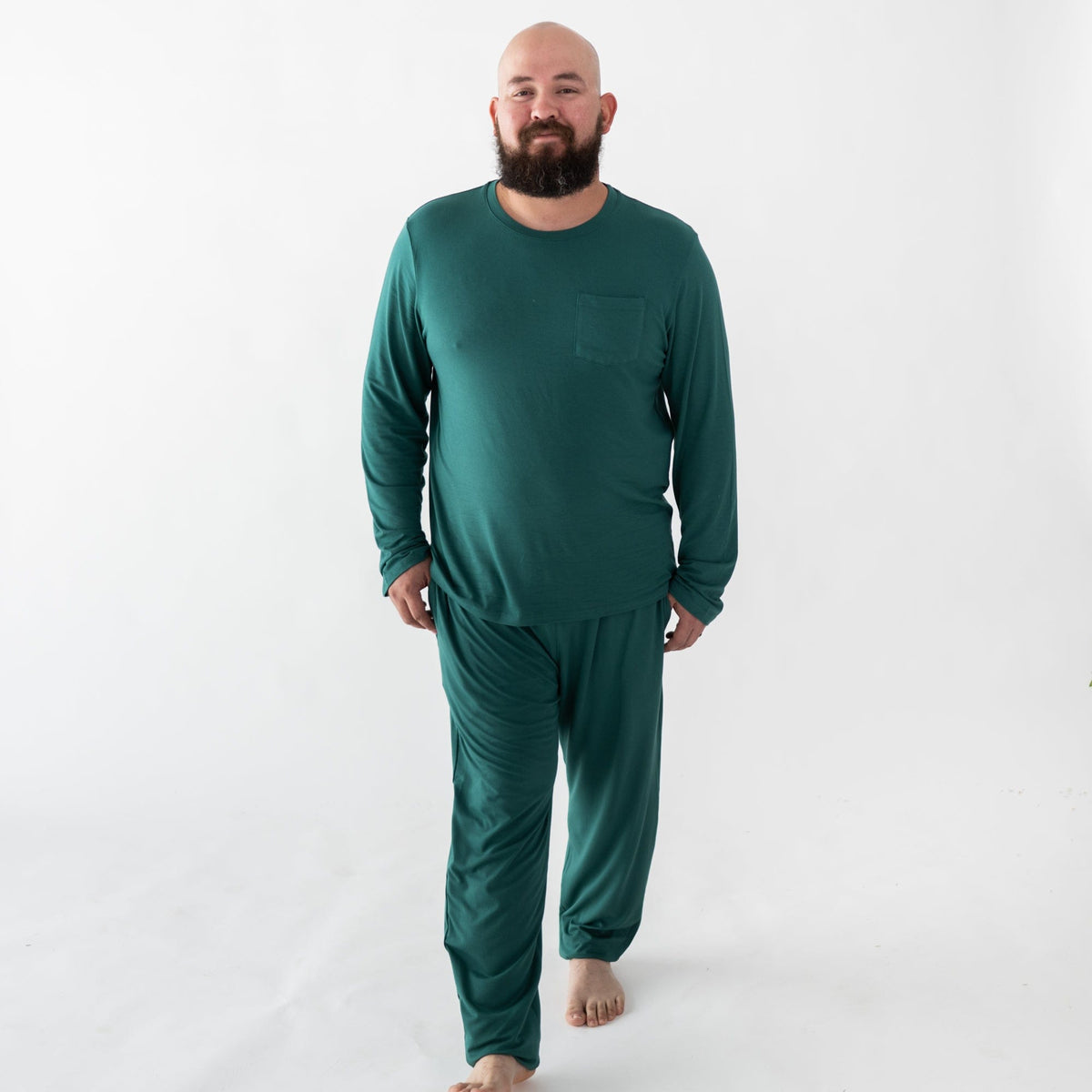 Man wearing Kyte Baby men's jogger set in Emerald green