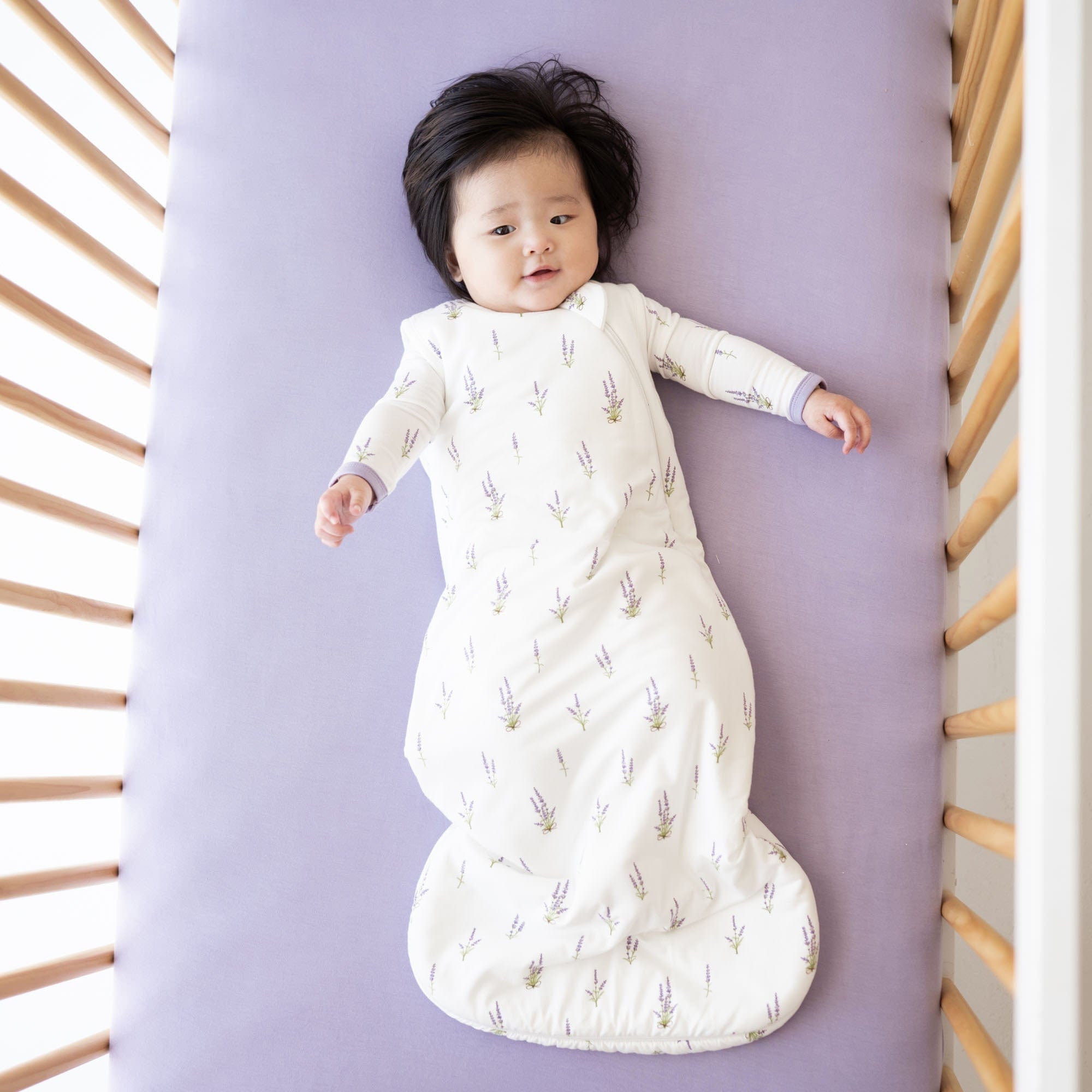 Infant wearing Kyte Baby Sleep Bag in Lavender 1.0