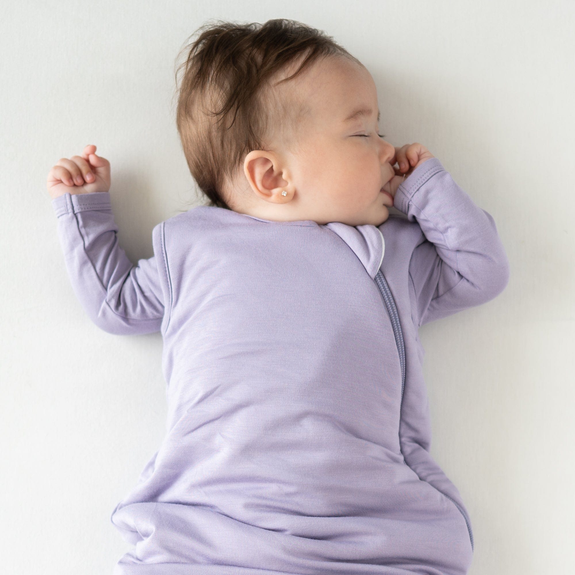 Baby wearing Kyte Baby bamboo Sleep Bag 1.0 in Taro Purple