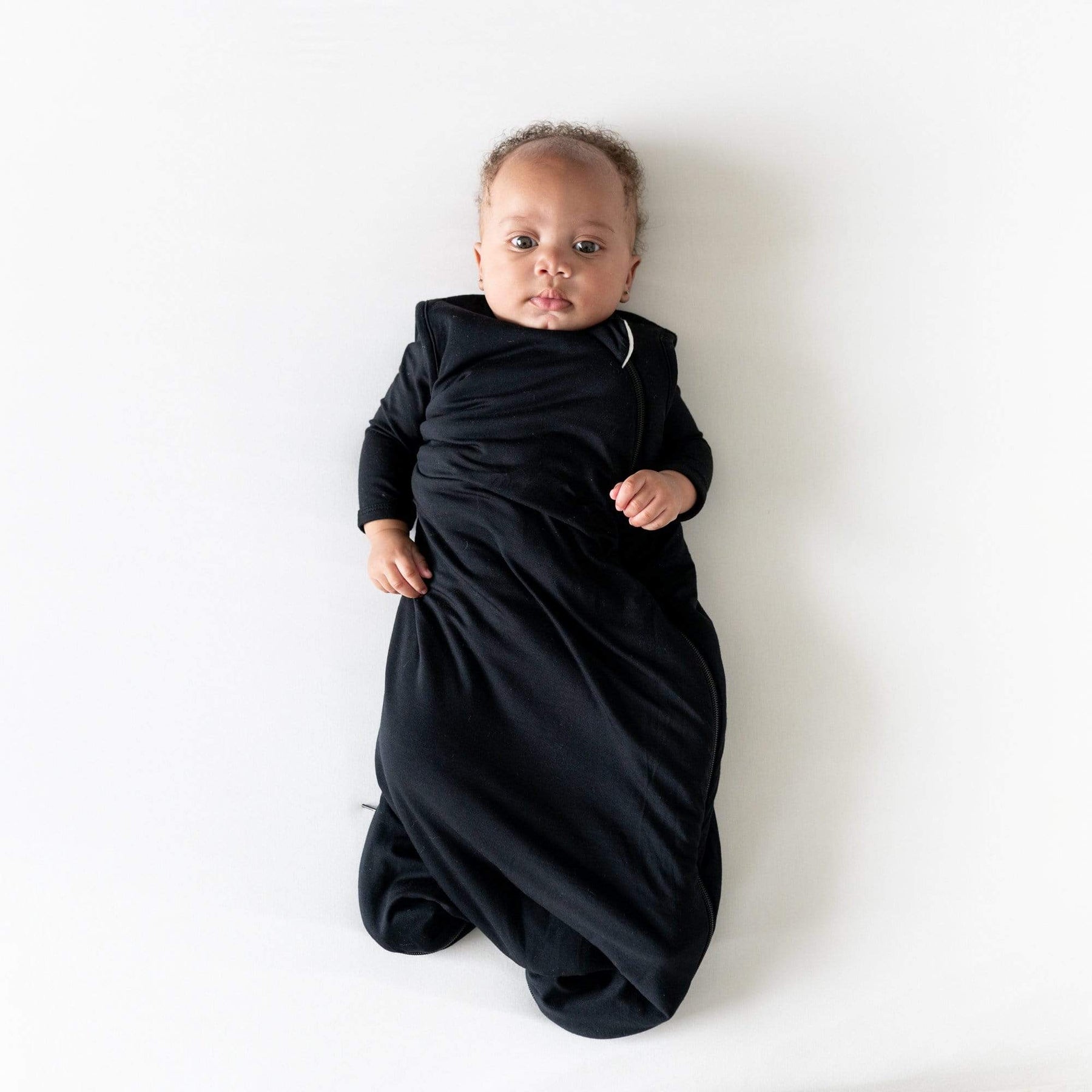 Baby wearing Kyte Baby bamboo Sleep Bag in Midnight 2.5