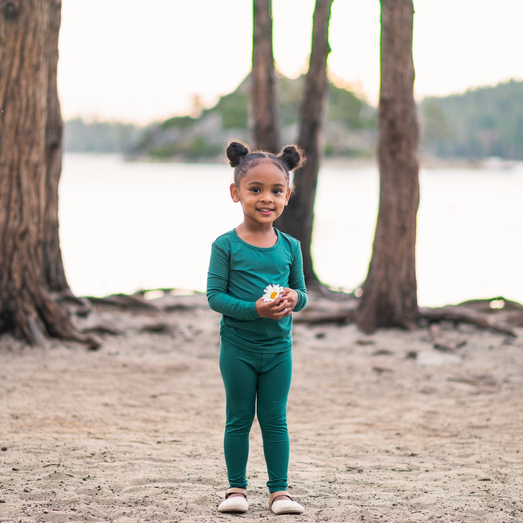 Toddler wearing two piece Kyte Baby Long Sleeve Pajamas in Emerald