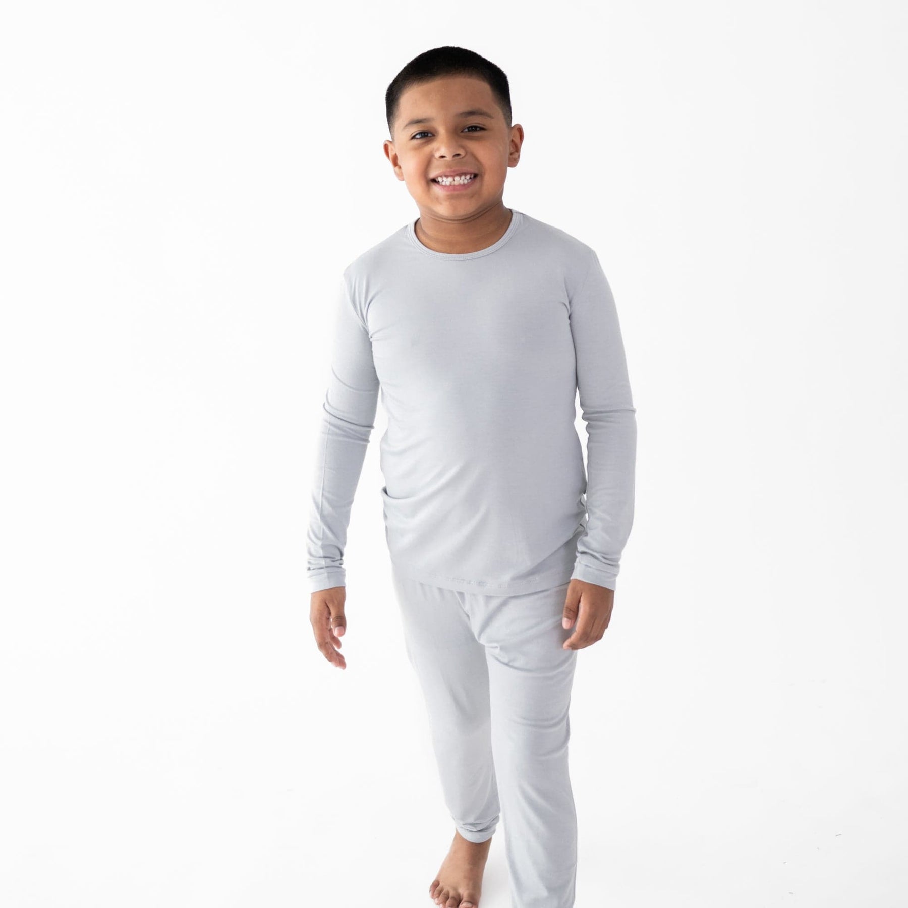 Child wearing Kyte Baby Long Sleeve Pajamas in Storm