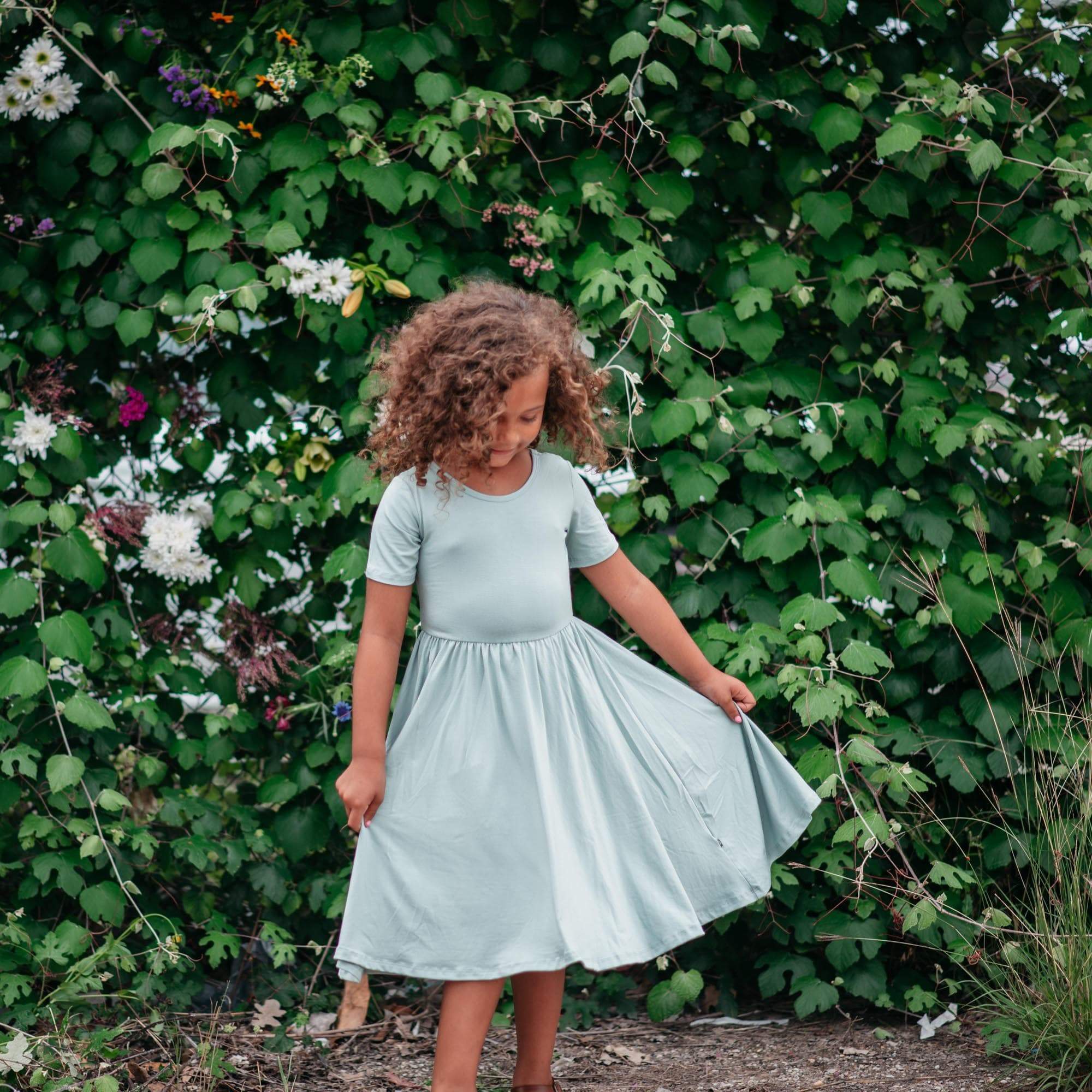 Girl wearing Kyte Baby Twirl Dress in Sage