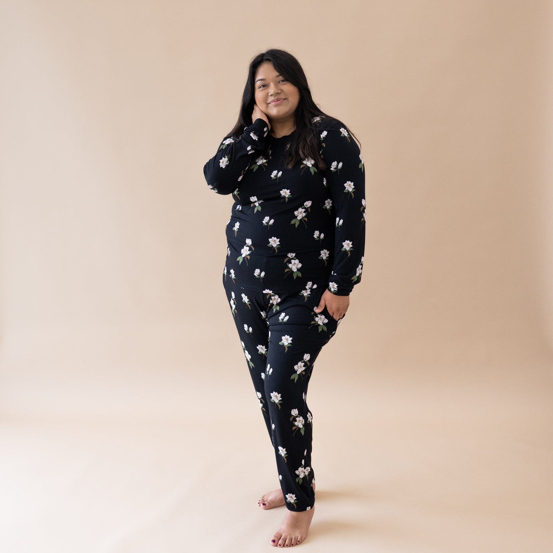 Woman wearing Kyte Baby women's jogger pajama set in Big Midnight Magnolia
