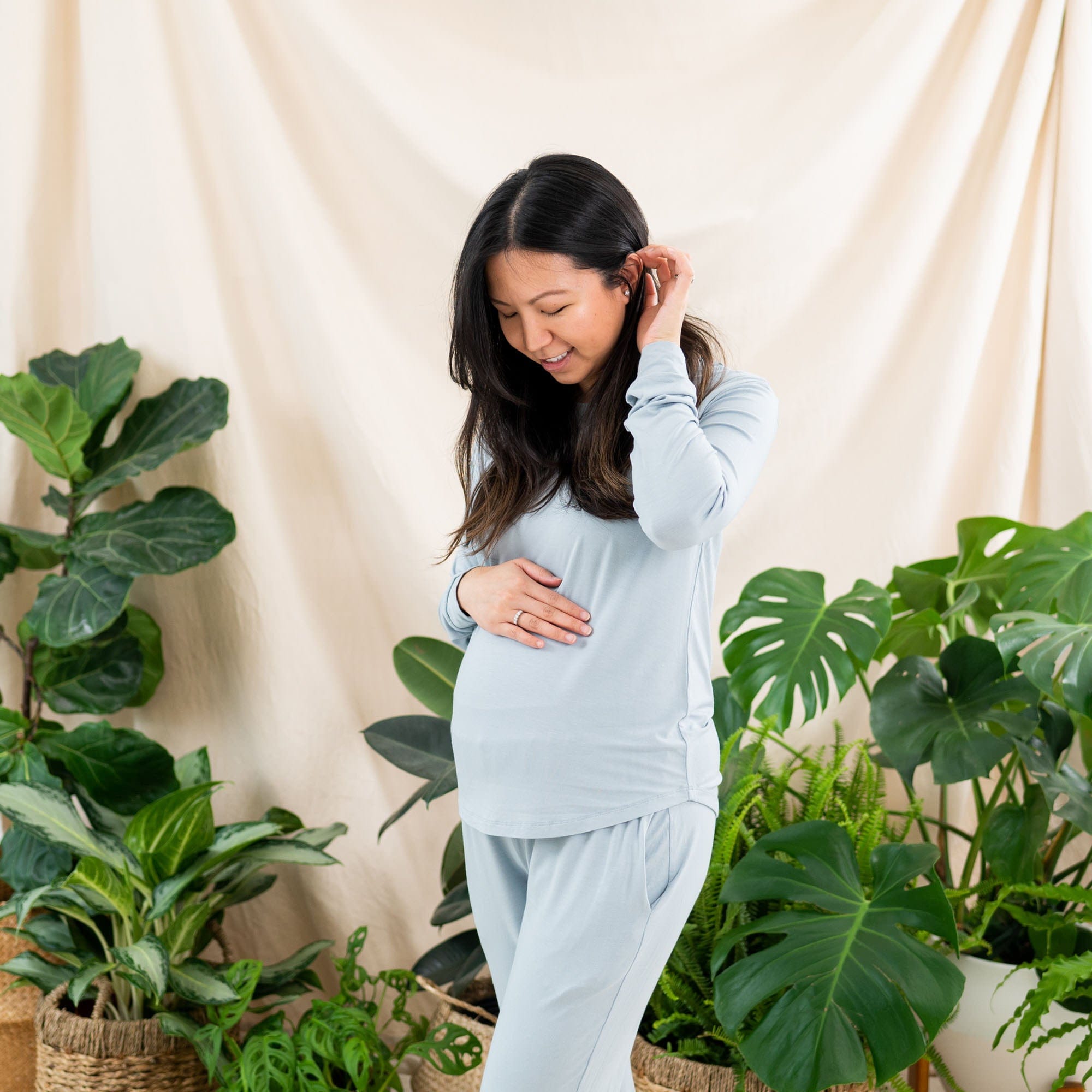 Woman wearing Kyte Baby women's jogger pajama set in Fog blue