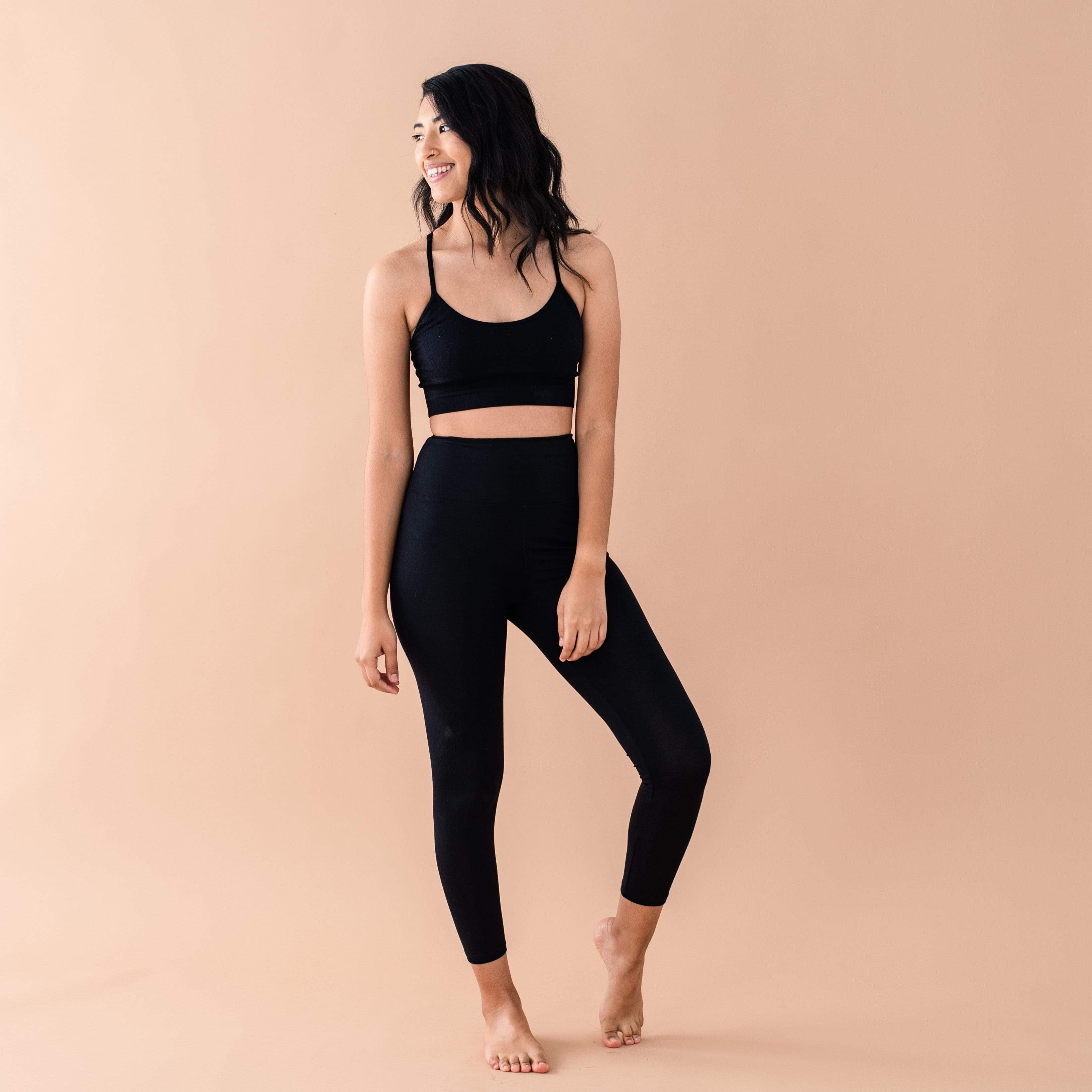 Woman wearing Kyte Baby Women's high-waisted Leggings in Midnight