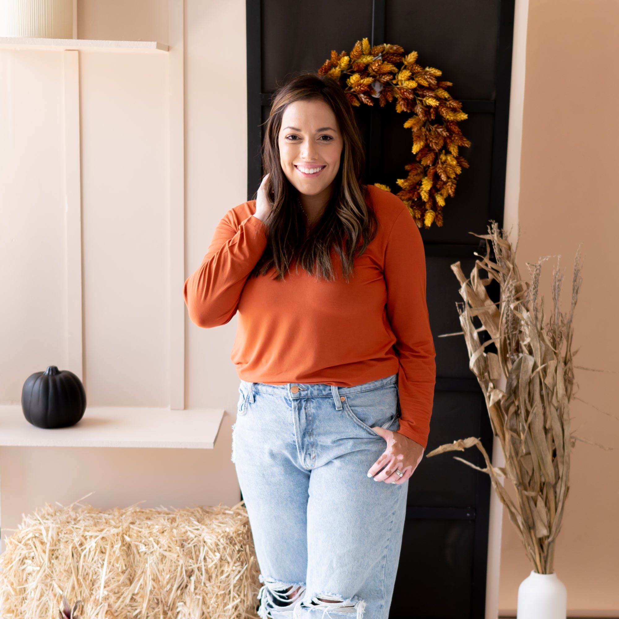 Woman modeling Long Sleeve Scoop Neck Tee in Rust