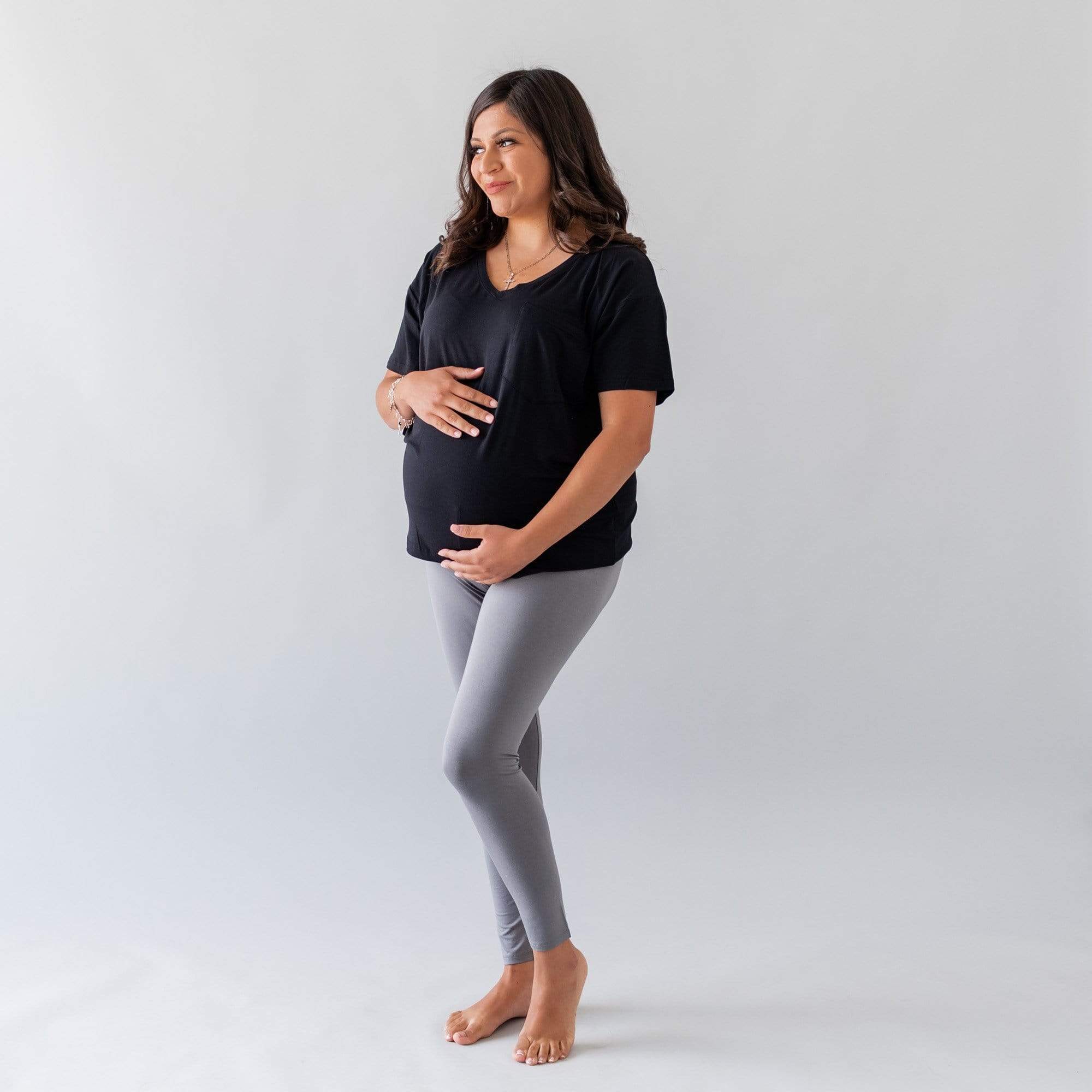 Pregnant woman wearing Kyte Baby Women's Relaxed Fit V-Neck in Midnight black