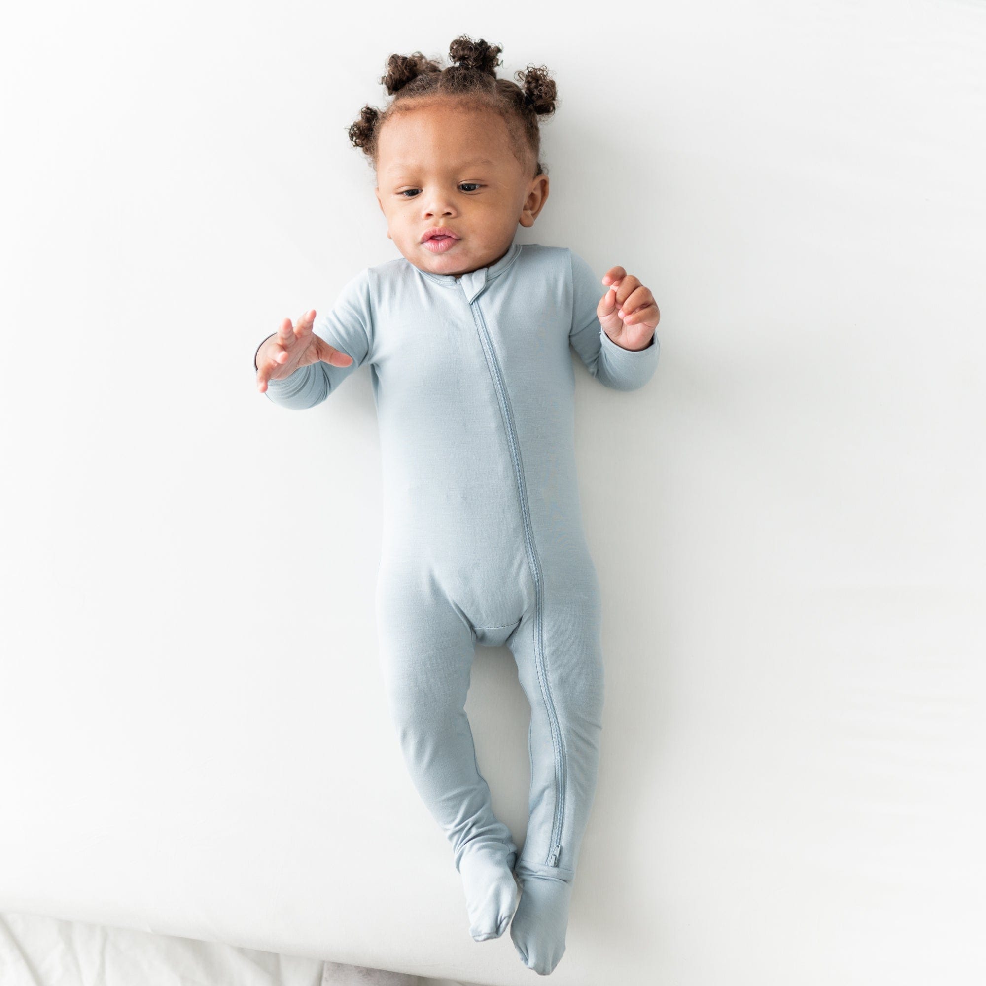 Baby wearing Kyte Baby breathable bamboo Zippered Footie in Fog